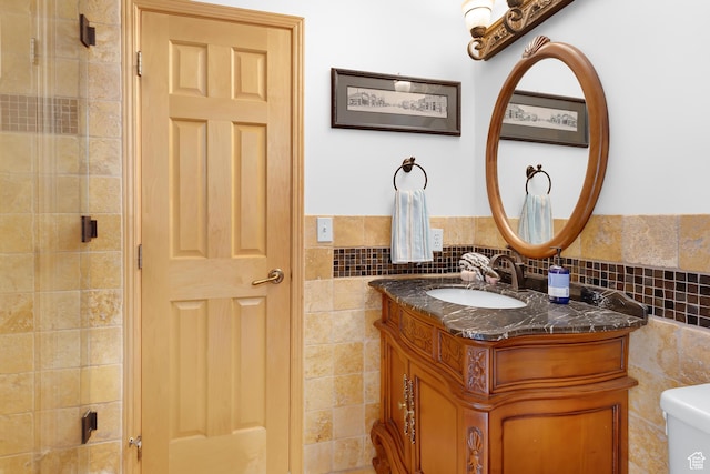 7340 Buckboard Dr N, Park City, UT 84098 - bathroom featuring tile walls, vanity, toilet, a tile shower, and a wainscoted wall