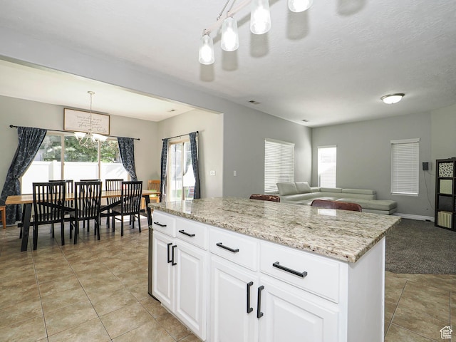 385 E 570 S, American Fork, UT 84003 - kitchen with a chandelier, a center island, white cabinets, and light stone countertops