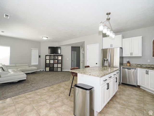 385 E 570 S, American Fork, UT 84003 - kitchen featuring stainless steel appliances, light colored carpet, light tile patterned flooring, light stone counters, and white cabinets