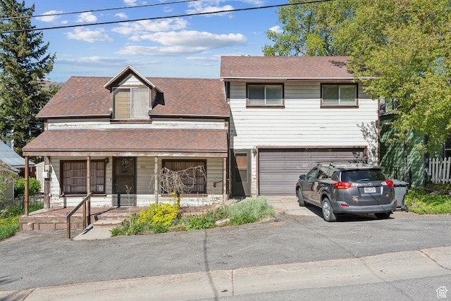 1020 Woodside Ave, Park City, UT 84060 - view of front of house with asphalt driveway, a porch, an attached garage, and a shingled roof