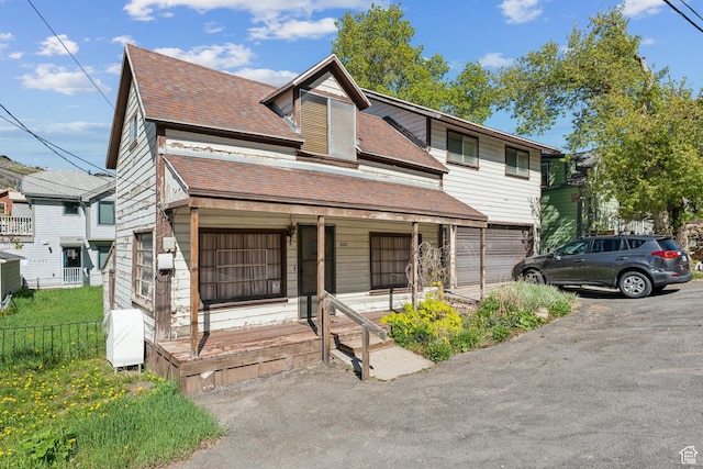 1020 Woodside Ave, Park City, UT 84060 - view of front of property featuring a porch, a shingled roof, and asphalt driveway