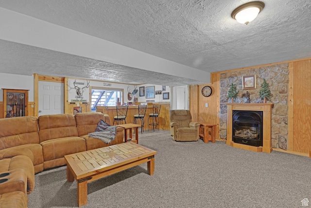 3966 W 2200 N, Plain City, UT 84404 - living area featuring a textured ceiling, carpet floors, wooden walls, and a glass covered fireplace