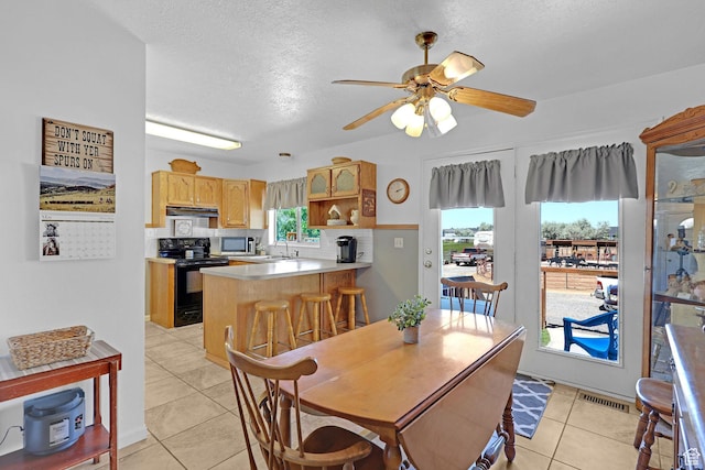3966 W 2200 N, Plain City, UT 84404 - dining room with light tile patterned floors, a ceiling fan, and a textured ceiling
