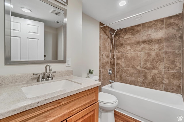 2867 S Cyprus Ln, Magna, UT 84044 - full bath with toilet, vanity, shower / bathtub combination, recessed lighting, and wood finished floors