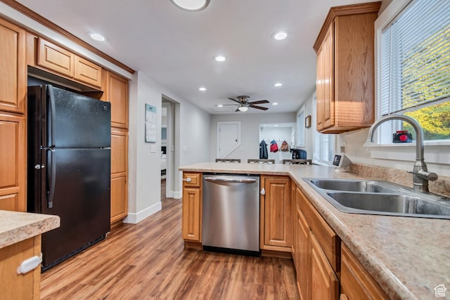 2867 S Cyprus Ln, Magna, UT 84044 - kitchen with stainless steel dishwasher, freestanding refrigerator, a sink, recessed lighting, and light wood-type flooring