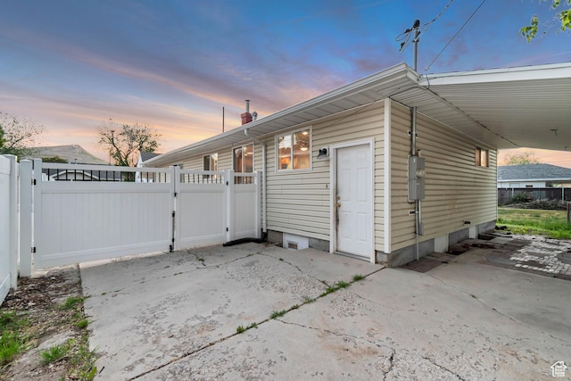2867 S Cyprus Ln, Magna, UT 84044 - view of side of home featuring a gate, a carport, and a chimney
