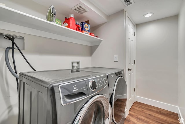 2867 S Cyprus Ln, Magna, UT 84044 - laundry area with wood finished floors, washer and clothes dryer, and baseboards