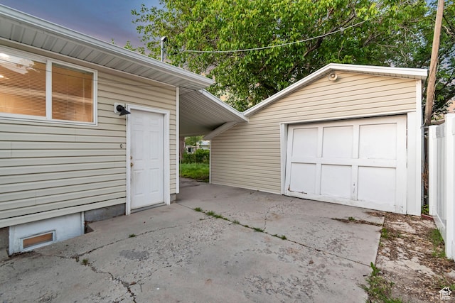 2867 S Cyprus Ln, Magna, UT 84044 - garage at dusk featuring driveway and a garage