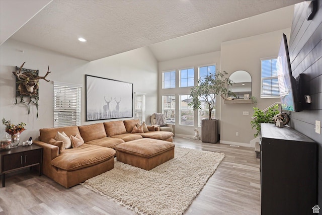 702 E 330 N, Vineyard, UT 84059 - living area with light wood-style floors, plenty of natural light, a textured ceiling, recessed lighting, and lofted ceiling