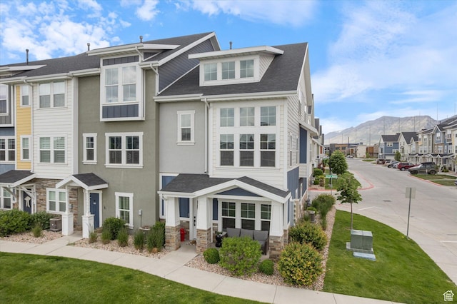702 E 330 N, Vineyard, UT 84059 - view of property featuring a mountain view, stone siding, a residential view, and a front lawn