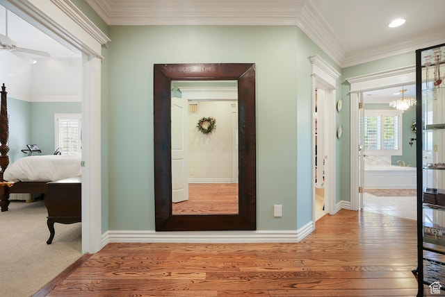 2051 E Normandywoods Ct, Holladay, UT 84117 - corridor featuring plenty of natural light, hardwood / wood-style floors, crown molding, a chandelier, and baseboards