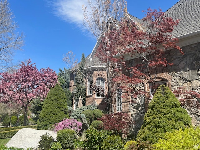 2051 E Normandywoods Ct, Holladay, UT 84117 - view of side of property with brick siding, stone siding, and roof with shingles