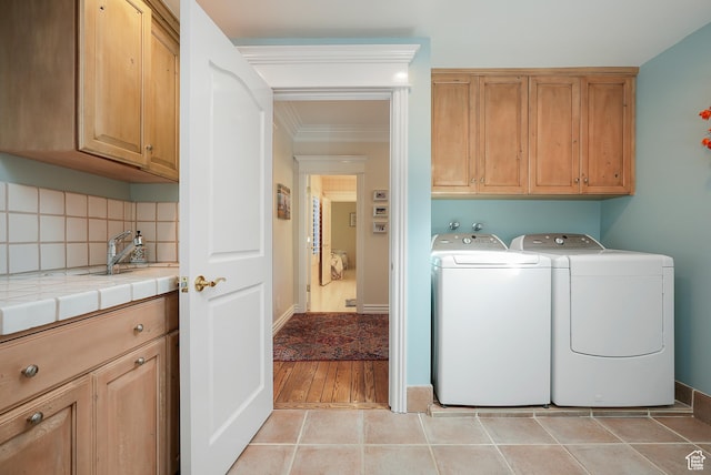 2051 E Normandywoods Ct, Holladay, UT 84117 - laundry area with cabinet space, independent washer and dryer, crown molding, and light tile patterned floors