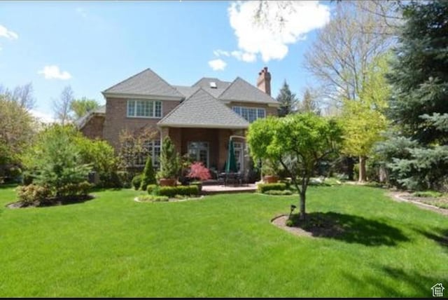 2051 E Normandywoods Ct, Holladay, UT 84117 - back of house with a lawn, a chimney, and a patio