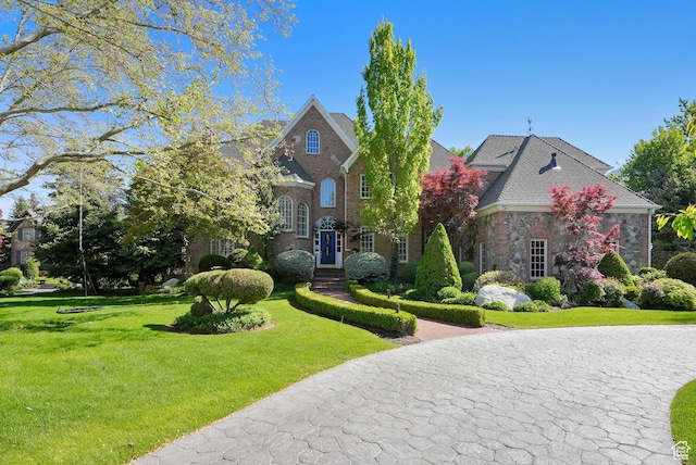 2051 E Normandywoods Ct, Holladay, UT 84117 - colonial house with a front yard and brick siding