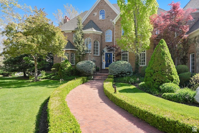 2051 E Normandywoods Ct, Holladay, UT 84117 - georgian-style home featuring brick siding, a front yard, and a chimney