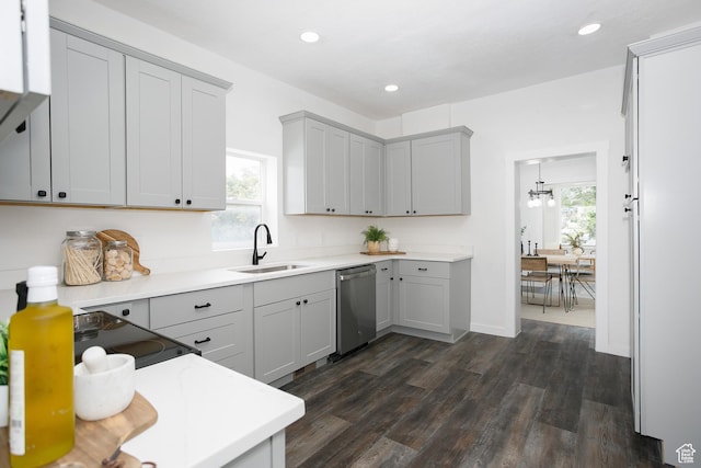2213 Ogden Ave, Ogden, UT 84401 - kitchen with stainless steel dishwasher, a sink, gray cabinetry, dark wood-style flooring, and light countertops