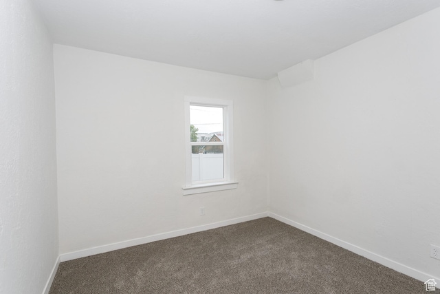 2213 Ogden Ave, Ogden, UT 84401 - spare room featuring dark colored carpet and baseboards