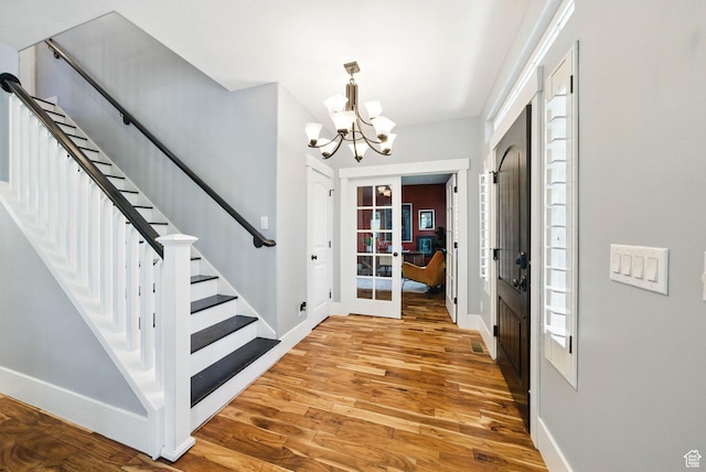 10416 S Vermillion Dr W, South Jordan, UT 84009 - entrance foyer with a chandelier, baseboards, wood finished floors, and stairs