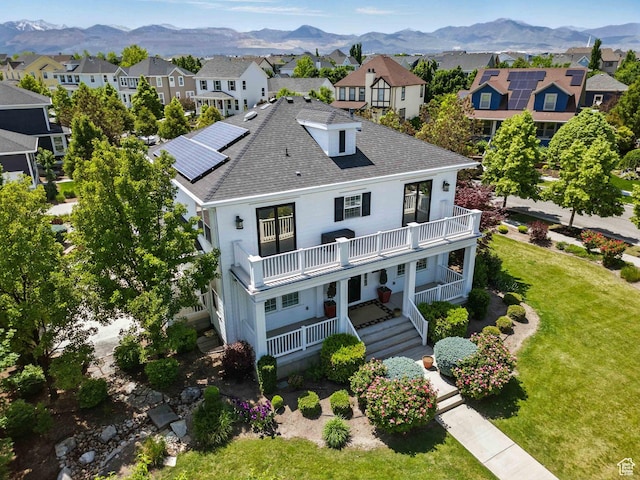 10416 S Vermillion Dr W, South Jordan, UT 84009 - view of front of house with a balcony, a front lawn, a mountain view, and a residential view