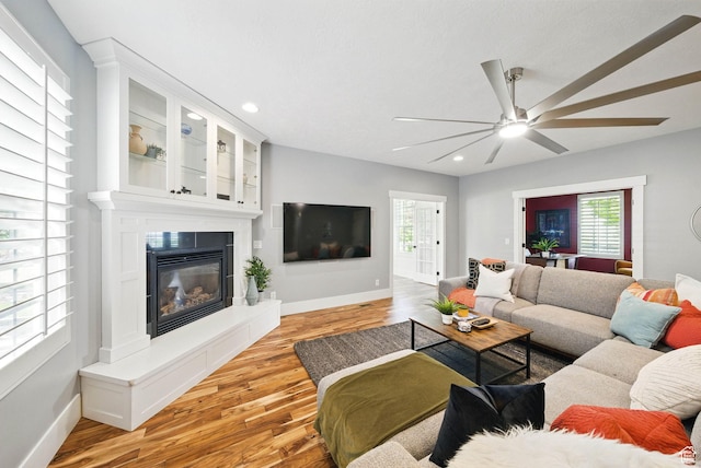 10416 S Vermillion Dr W, South Jordan, UT 84009 - living room featuring baseboards, light wood-type flooring, healthy amount of natural light, a ceiling fan, and recessed lighting