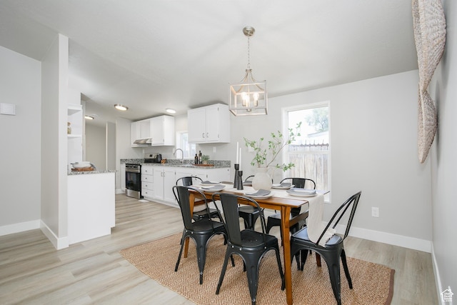 1623 W Claybourne Ave S, West Valley City, UT 84119 - dining area with a chandelier, baseboards, and light wood finished floors