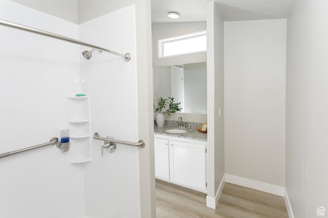 1623 W Claybourne Ave S, West Valley City, UT 84119 - full bath with wood finished floors, vanity, a shower, and baseboards
