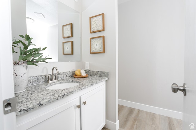 1623 W Claybourne Ave S, West Valley City, UT 84119 - bathroom featuring vanity, wood finished floors, and baseboards