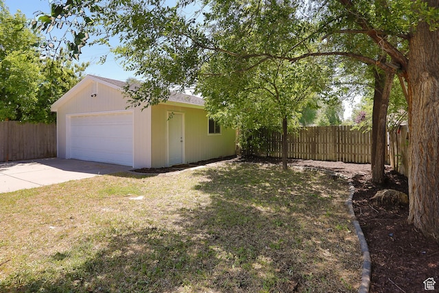 1623 W Claybourne Ave S, West Valley City, UT 84119 - view of yard featuring concrete driveway, an outbuilding, and a garage