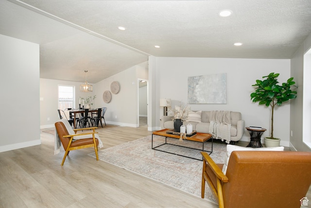1623 W Claybourne Ave S, West Valley City, UT 84119 - living area featuring light wood-type flooring, baseboards, lofted ceiling, and recessed lighting