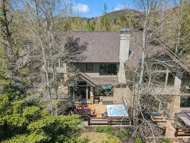 2464 Deer Lake Dr, Park City, UT 84060 - rear view of house featuring an outdoor living space, a chimney, a patio area, and a shingled roof