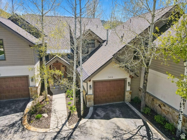 2464 Deer Lake Dr, Park City, UT 84060 - view of front of home with stone siding, asphalt driveway, and stucco siding