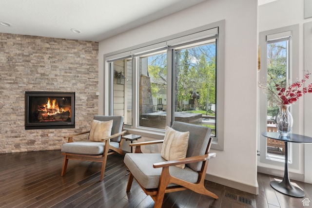2464 Deer Lake Dr, Park City, UT 84060 - sitting room with wood finished floors, a stone fireplace, healthy amount of natural light, and recessed lighting