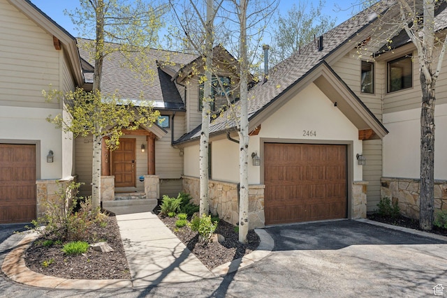 2464 Deer Lake Dr, Park City, UT 84060 - view of front of house featuring stone siding, asphalt driveway, and roof with shingles