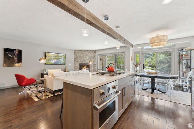 2464 Deer Lake Dr, Park City, UT 84060 - kitchen with appliances with stainless steel finishes, beamed ceiling, dark wood-style floors, a textured ceiling, and a stone fireplace