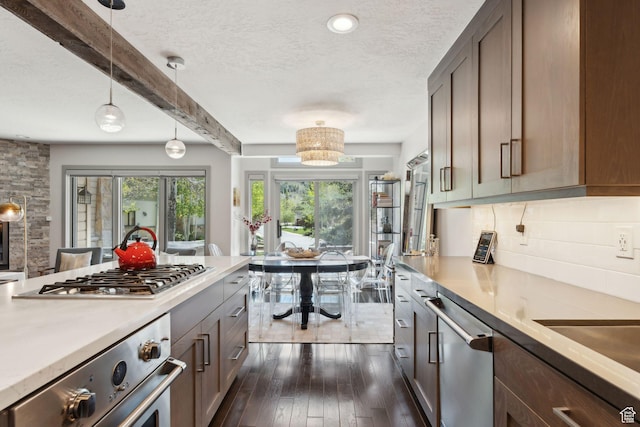 2464 Deer Lake Dr, Park City, UT 84060 - kitchen featuring appliances with stainless steel finishes, a textured ceiling, light countertops, backsplash, and dark wood finished floors