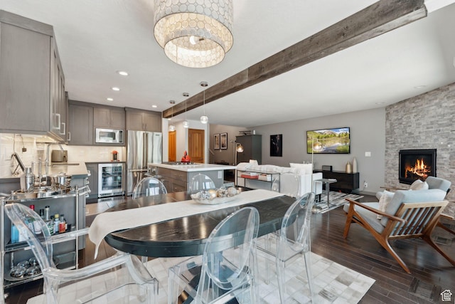2464 Deer Lake Dr, Park City, UT 84060 - dining space featuring wine cooler, dark wood-style flooring, a fireplace, beam ceiling, and recessed lighting