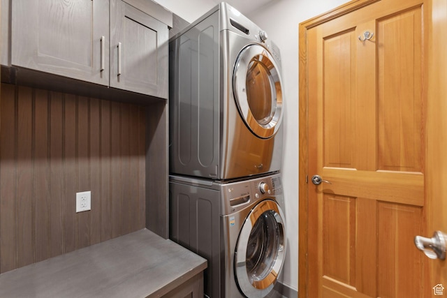 2464 Deer Lake Dr, Park City, UT 84060 - laundry room featuring stacked washing machine and dryer and cabinet space