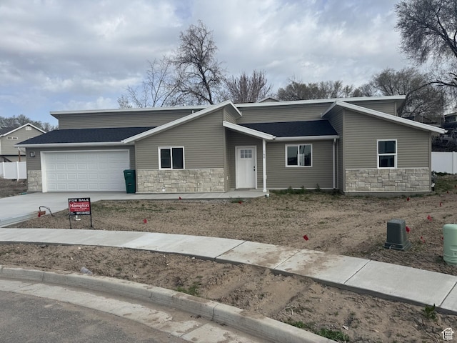 160 S 50 W, Clearfield, UT 84015 - mid-century inspired home with stone siding, an attached garage, concrete driveway, and a shingled roof