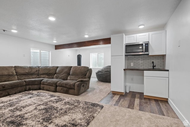 2076 E Granite Ln N Unit 145, Eagle Mountain, UT 84005 - carpeted living area with a sink, recessed lighting, wood finished floors, baseboards, and a textured ceiling