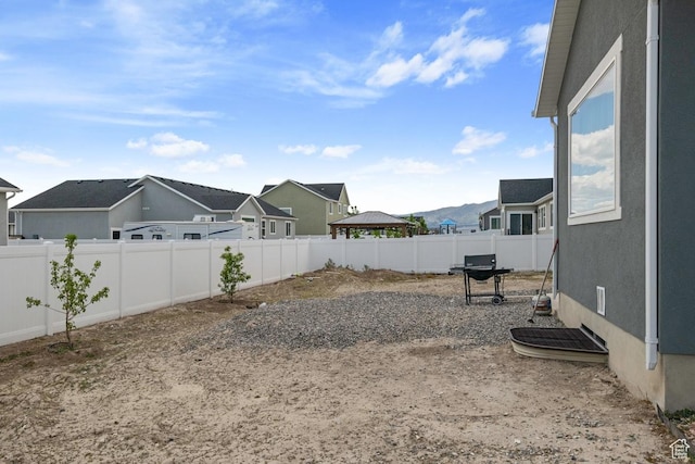2076 E Granite Ln N Unit 145, Eagle Mountain, UT 84005 - fenced backyard featuring a residential view and a gazebo