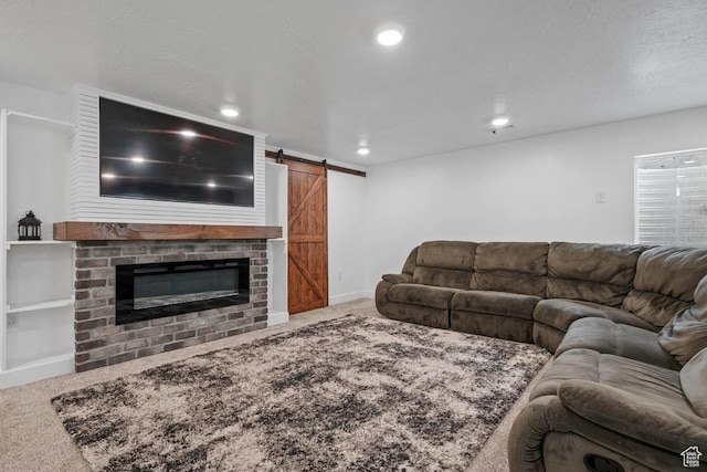 2076 E Granite Ln N Unit 145, Eagle Mountain, UT 84005 - carpeted living room featuring a barn door, recessed lighting, and a fireplace