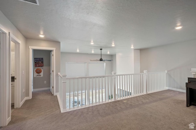2076 E Granite Ln N Unit 145, Eagle Mountain, UT 84005 - hallway with carpet flooring, recessed lighting, baseboards, a textured ceiling, and an upstairs landing