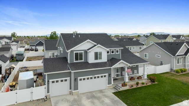 2076 E Granite Ln N Unit 145, Eagle Mountain, UT 84005 - view of front of house with a gate, roof with shingles, a residential view, and concrete driveway