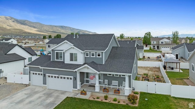 2076 E Granite Ln N Unit 145, Eagle Mountain, UT 84005 - view of front of home with a gate, concrete driveway, a gazebo, a shingled roof, and a residential view