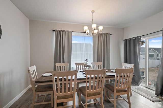 2076 E Granite Ln N Unit 145, Eagle Mountain, UT 84005 - dining area with a chandelier, wood finished floors, and baseboards