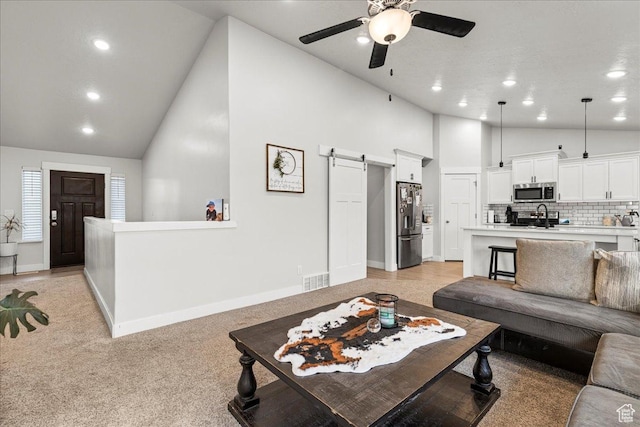 464 S Trejo Ridge Rd, Grantsville, UT 84029 - living area with a barn door, high vaulted ceiling, ceiling fan, recessed lighting, and baseboards