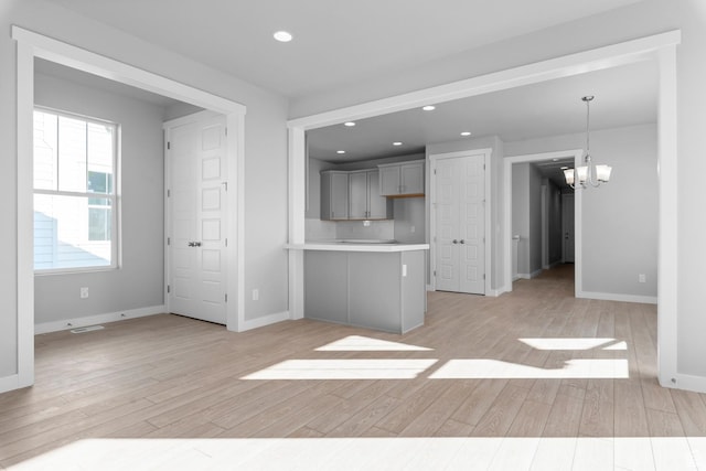 9806 N Willowbank Dr, Highland, UT 84003 - kitchen with light countertops, light wood-style flooring, a chandelier, recessed lighting, and gray cabinetry