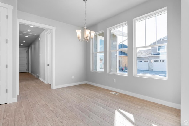 9806 N Willowbank Dr, Highland, UT 84003 - spare room featuring a chandelier, baseboards, and light wood finished floors