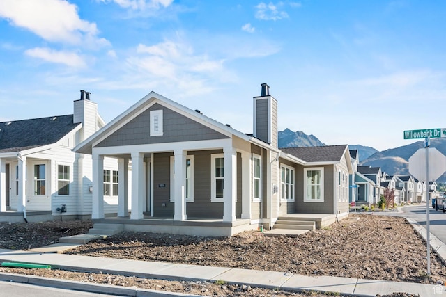 9806 N Willowbank Dr, Highland, UT 84003 - view of front of house with a porch, a chimney, and a residential view